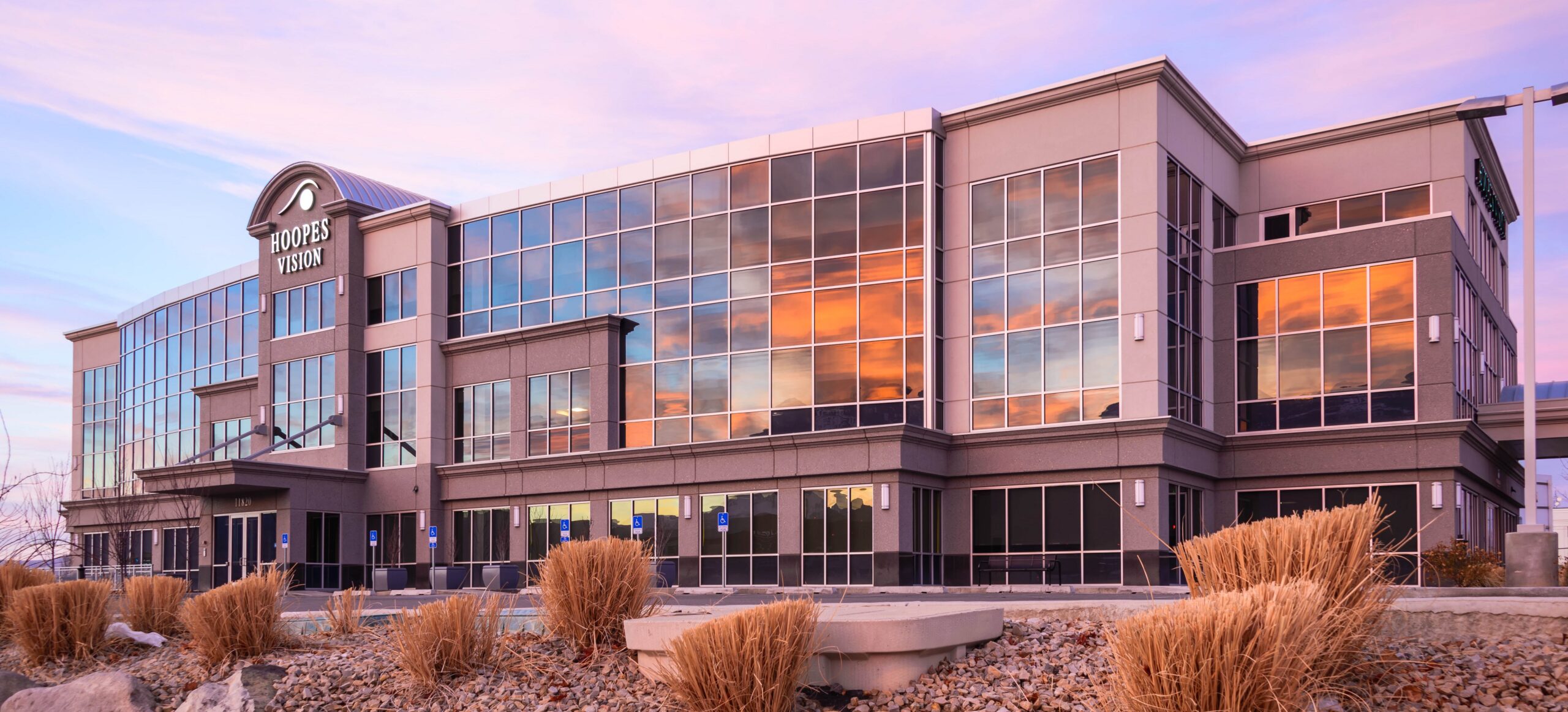 Hoopes Vision eye care and surgery center building in Draper, Utah, at sunset